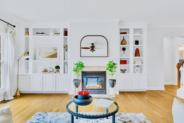 living room featuring hardwood / wood-style floors, a fireplace, and plenty of natural light