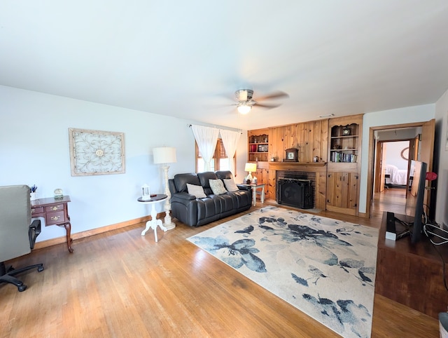 living room featuring light wood-type flooring and ceiling fan