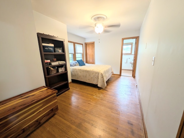 bedroom with multiple windows, light hardwood / wood-style floors, and ceiling fan