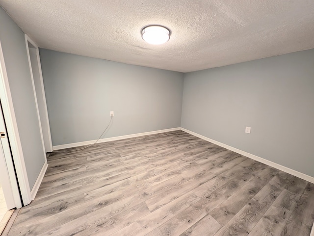 unfurnished bedroom with a textured ceiling and light wood-type flooring