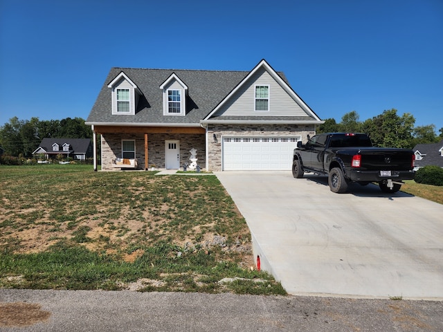 view of front of home featuring a front yard, a garage, and covered porch