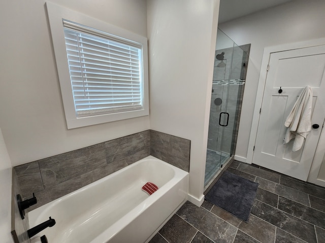 bathroom featuring separate shower and tub