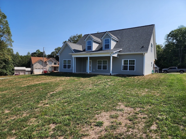 new england style home with covered porch and a front lawn