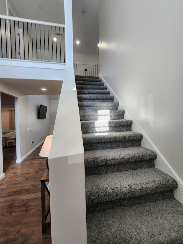 staircase with hardwood / wood-style flooring