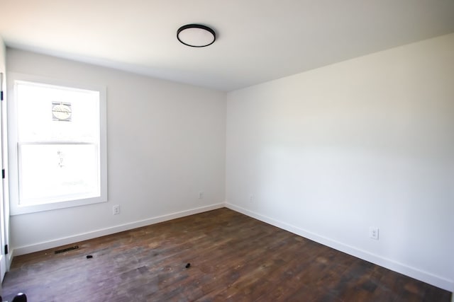 spare room featuring dark hardwood / wood-style floors