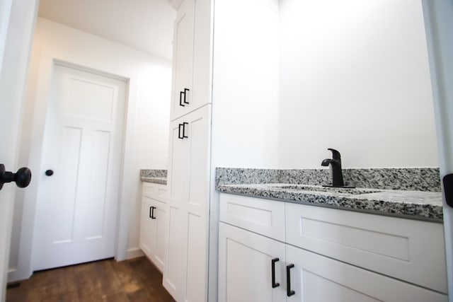 bathroom featuring vanity and hardwood / wood-style flooring