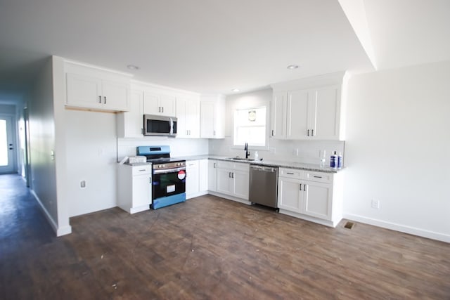 kitchen featuring dark hardwood / wood-style flooring, white cabinetry, sink, and stainless steel appliances