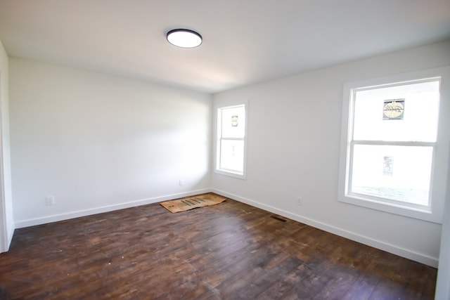 unfurnished room featuring dark hardwood / wood-style flooring