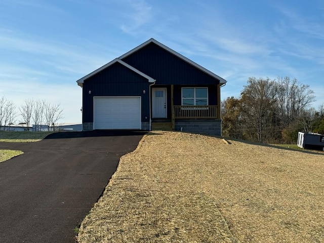 view of front of property featuring covered porch and a garage