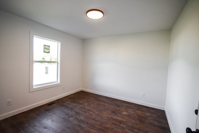 spare room with dark hardwood / wood-style flooring