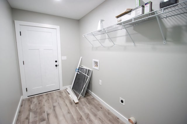 washroom featuring light hardwood / wood-style flooring, washer hookup, and hookup for an electric dryer