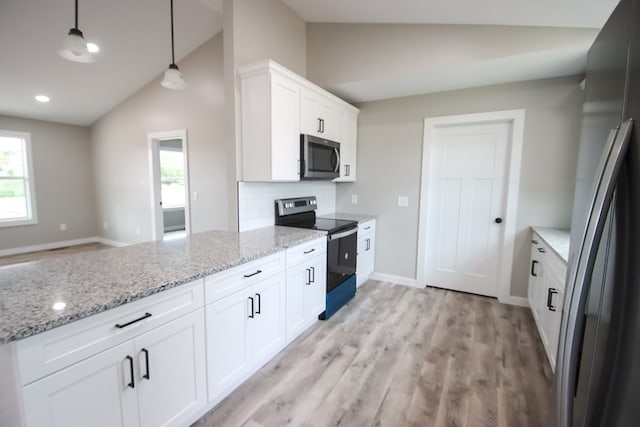 kitchen featuring white cabinets, hanging light fixtures, vaulted ceiling, and appliances with stainless steel finishes