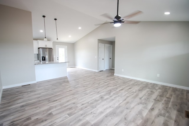 unfurnished living room featuring ceiling fan, lofted ceiling, and light hardwood / wood-style floors