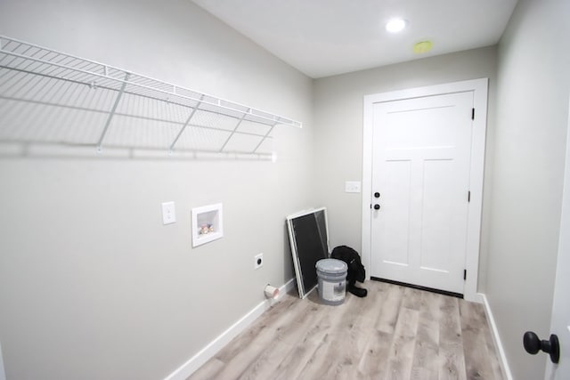 washroom with hookup for an electric dryer, hookup for a washing machine, and light hardwood / wood-style floors