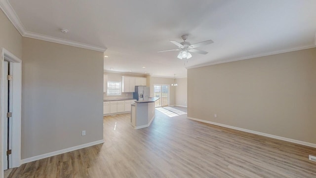 unfurnished living room featuring ceiling fan, light hardwood / wood-style flooring, and ornamental molding