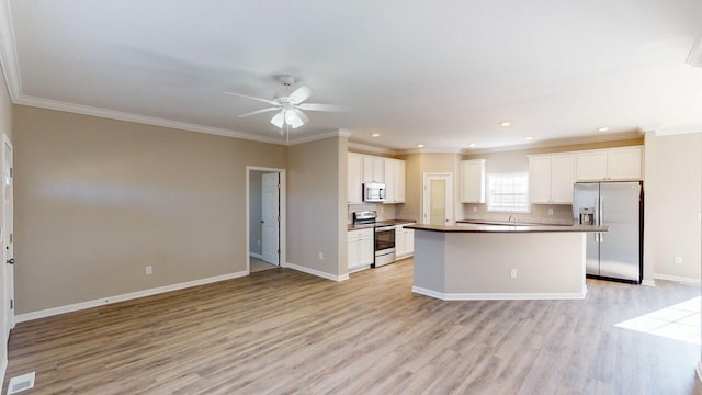 kitchen featuring white cabinetry, a center island, light wood-type flooring, and stainless steel appliances