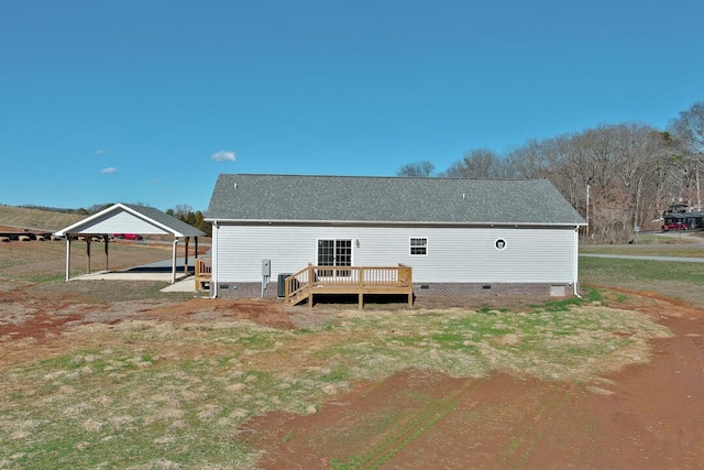 back of house with a wooden deck, a yard, and a carport