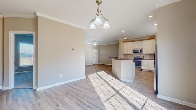 kitchen featuring ornamental molding, white cabinets, pendant lighting, light hardwood / wood-style floors, and stainless steel appliances