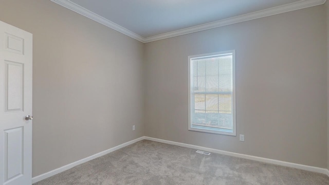 carpeted spare room featuring crown molding