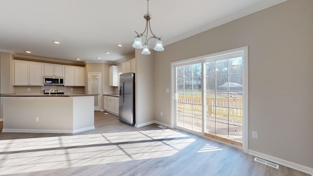 kitchen with white cabinets, an inviting chandelier, decorative light fixtures, light wood-type flooring, and stainless steel appliances