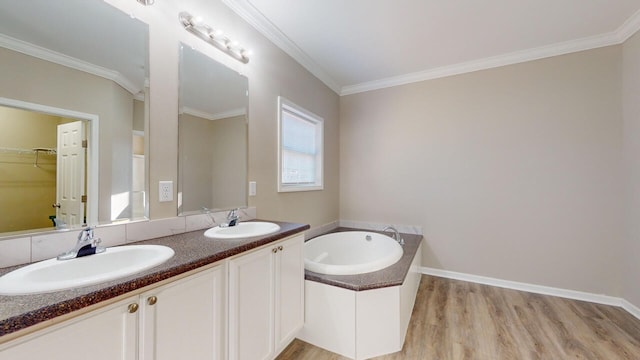 bathroom with a washtub, vanity, hardwood / wood-style flooring, and ornamental molding