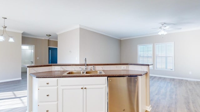 kitchen with dishwasher, sink, an island with sink, decorative light fixtures, and white cabinets