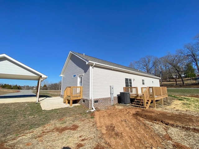 rear view of house featuring central air condition unit and a deck