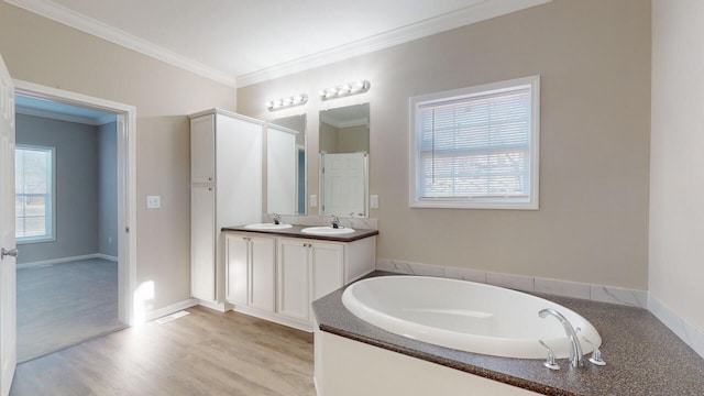 bathroom with wood-type flooring, vanity, a bath, and ornamental molding