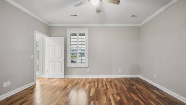 empty room with dark hardwood / wood-style floors, ceiling fan, and crown molding