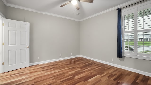 empty room with ornamental molding, hardwood / wood-style flooring, and a healthy amount of sunlight