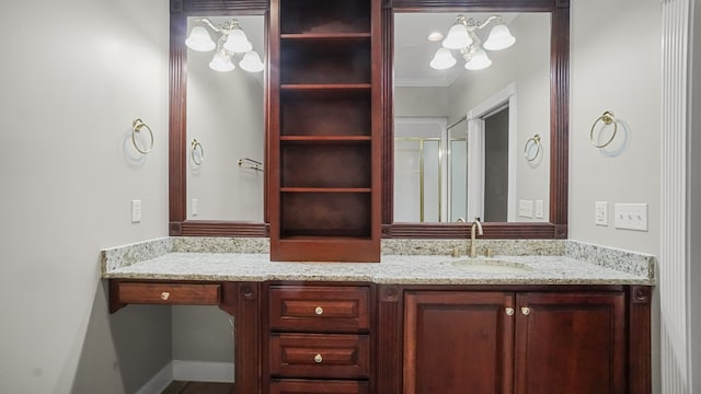 bathroom featuring crown molding, vanity, and a shower with shower door