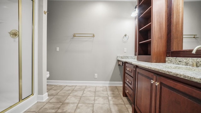 bathroom with tile patterned floors, toilet, vanity, and walk in shower