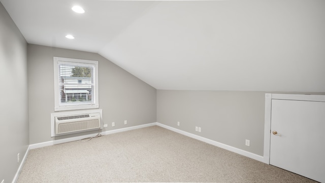 bonus room with carpet flooring, a wall mounted AC, and lofted ceiling