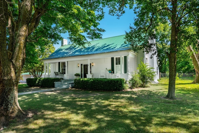 view of front of house with a front yard and a porch