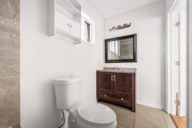 bathroom with tile patterned floors, vanity, and toilet