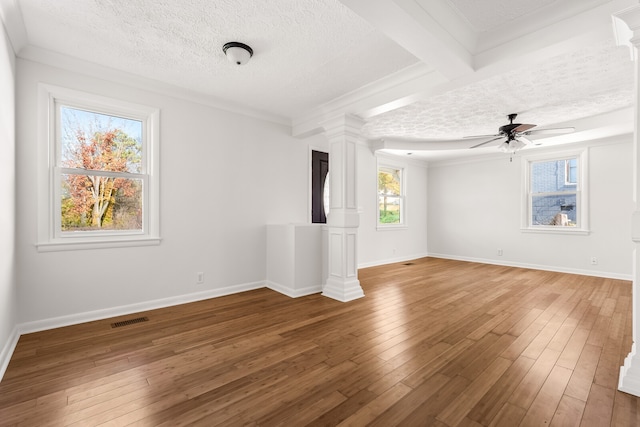 unfurnished living room featuring decorative columns, ceiling fan, a textured ceiling, and hardwood / wood-style flooring