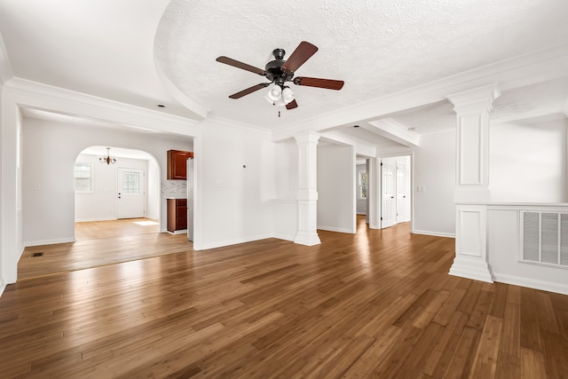 unfurnished living room with ceiling fan, crown molding, dark hardwood / wood-style flooring, and a textured ceiling