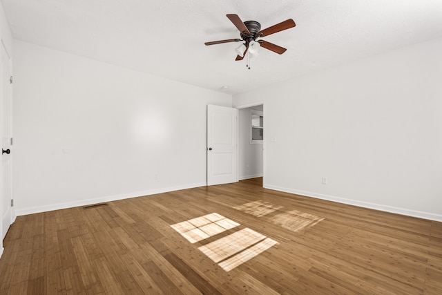 unfurnished room with wood-type flooring and ceiling fan