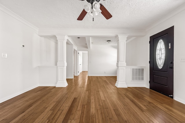 entryway featuring ceiling fan, decorative columns, crown molding, a textured ceiling, and hardwood / wood-style flooring