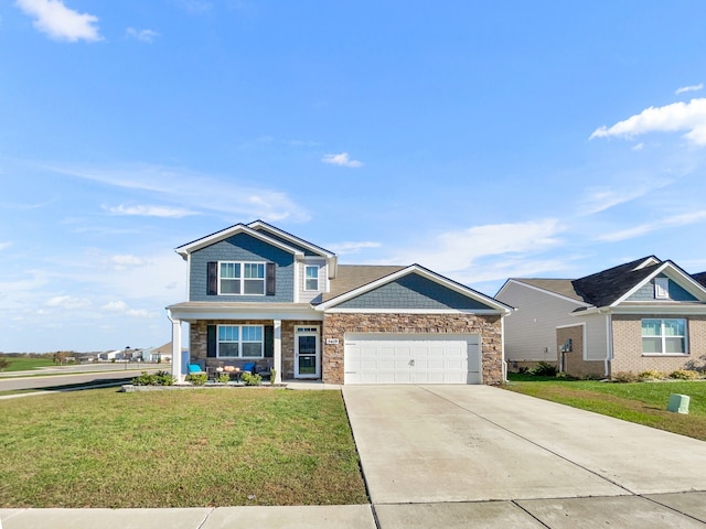 craftsman house with a front yard and a garage