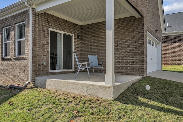 view of patio / terrace with a garage and a porch