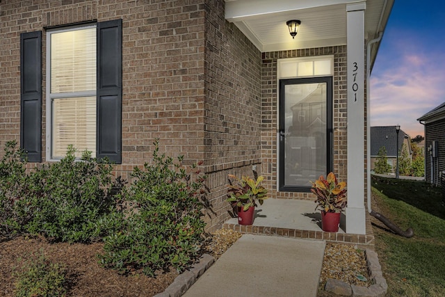 view of exterior entry at dusk