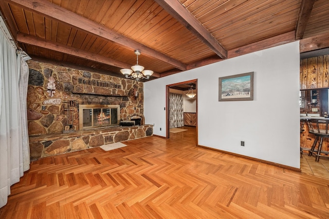 unfurnished living room featuring light parquet flooring, wooden ceiling, beamed ceiling, and a stone fireplace