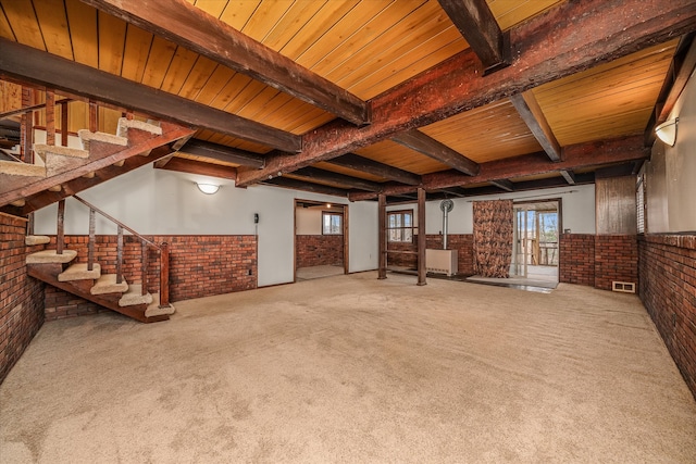 basement with wood ceiling, carpet flooring, and brick wall