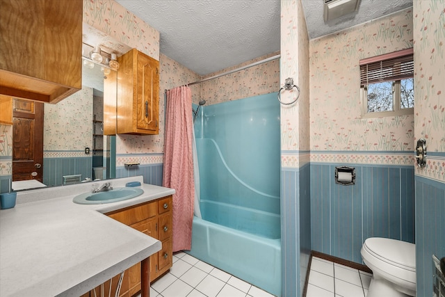 full bathroom with tile patterned floors, vanity, toilet, a textured ceiling, and shower / tub combo with curtain