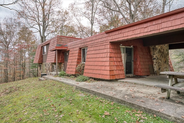 view of side of home featuring a lawn