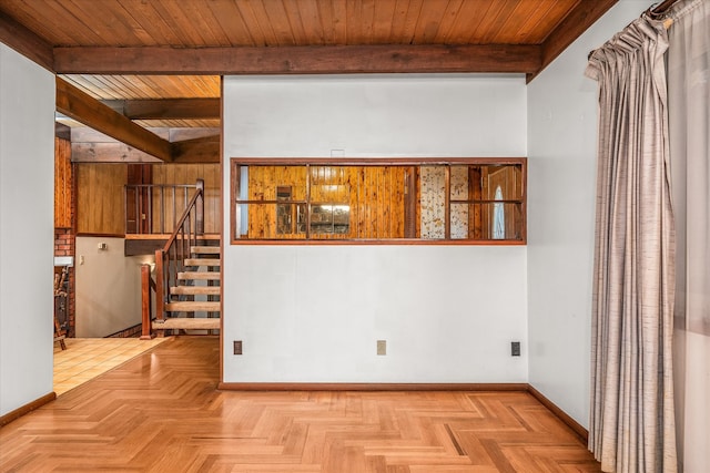 spare room with beamed ceiling, light parquet floors, and wooden ceiling