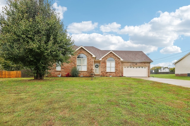 ranch-style house featuring a front yard and a garage