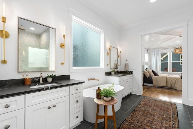 bathroom with vanity, hardwood / wood-style floors, a wealth of natural light, and ornamental molding