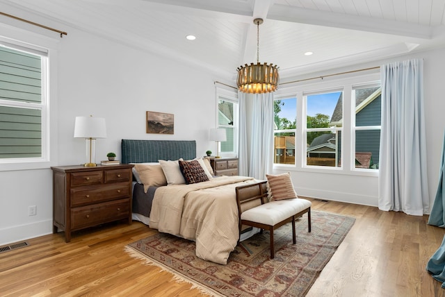 bedroom with beamed ceiling, light hardwood / wood-style floors, an inviting chandelier, and wooden ceiling